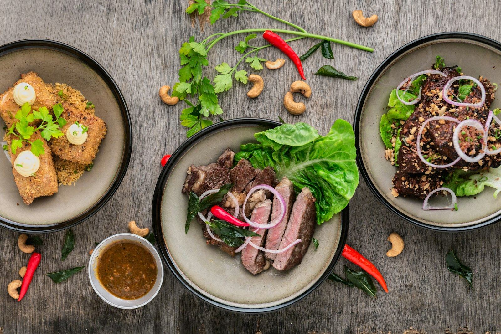 Plates of grilled meats and fresh salads